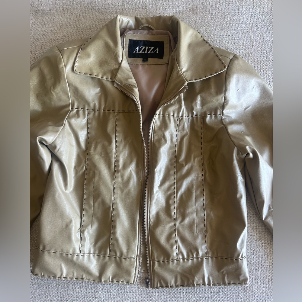 Aziza cream leather jacket with brown threading details.